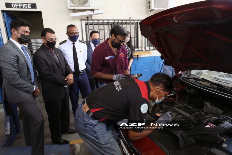 Minister of Works and Transport Rohan Sinanan, second from left, look on with Richie Sookhai of SDS, left, and Transport Commissioner Clive Clarke as inspectors Ronelle Sookhai and Faizul Juman use the new electronic system on a vehicle. AZP News/Azlan Mohammed