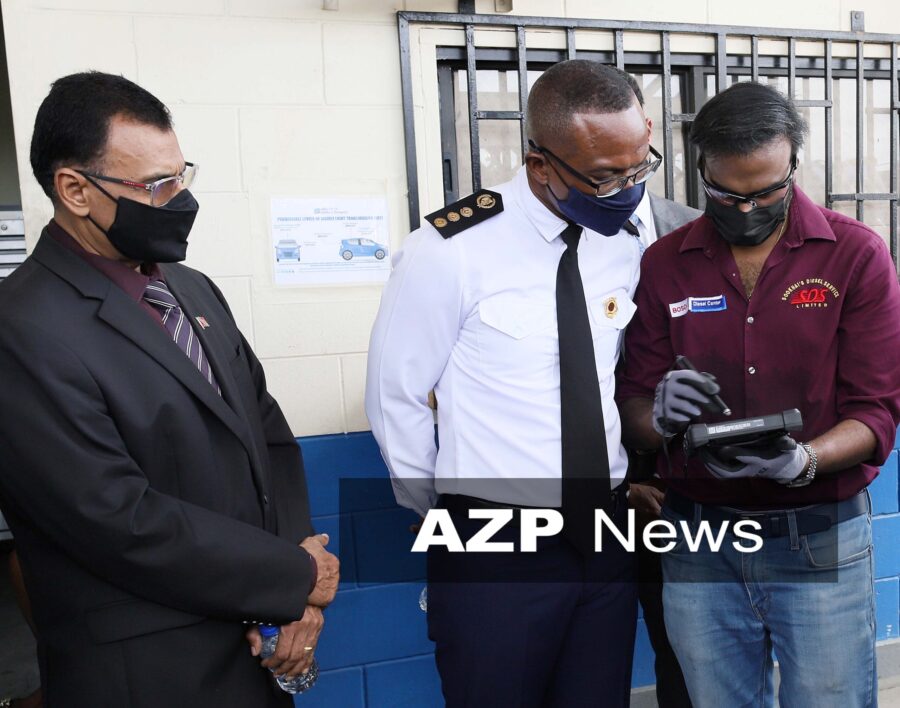 Ronelle Sookhai demonstrates the new EVIS system to Minister of Works and Transport Rohan Sinanan and Transport Commissioner Clive Clarke. AZP News/Azlan Mohammed