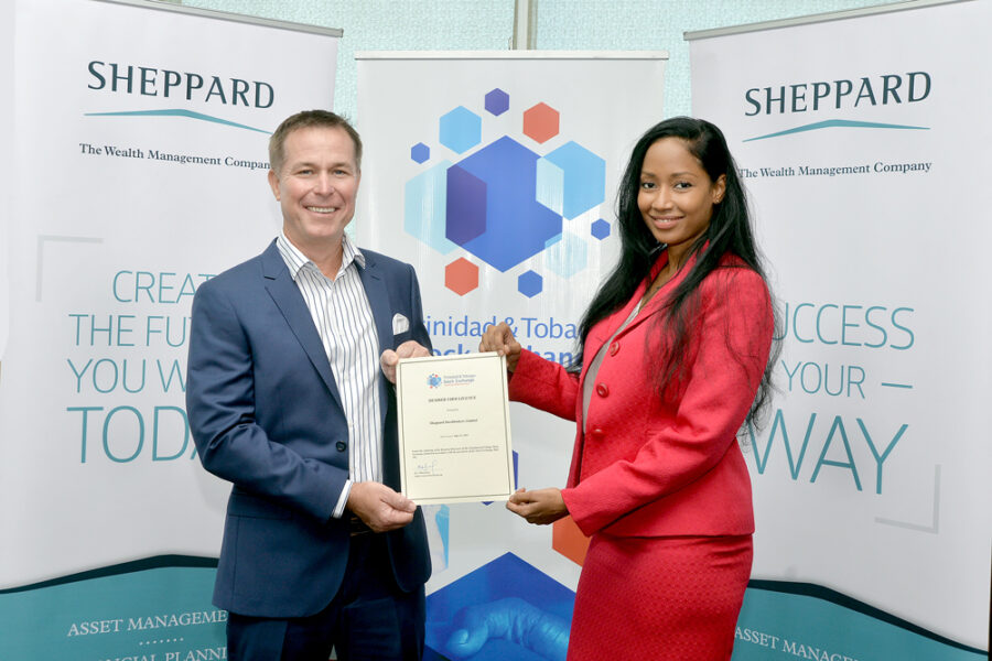 CEO of the TTSE Eva Mitchell presents CEO of Sheppard Stockbrokers Limited George Sheppard with the official Member Firm License for Sheppard Stockbrokers Limited.