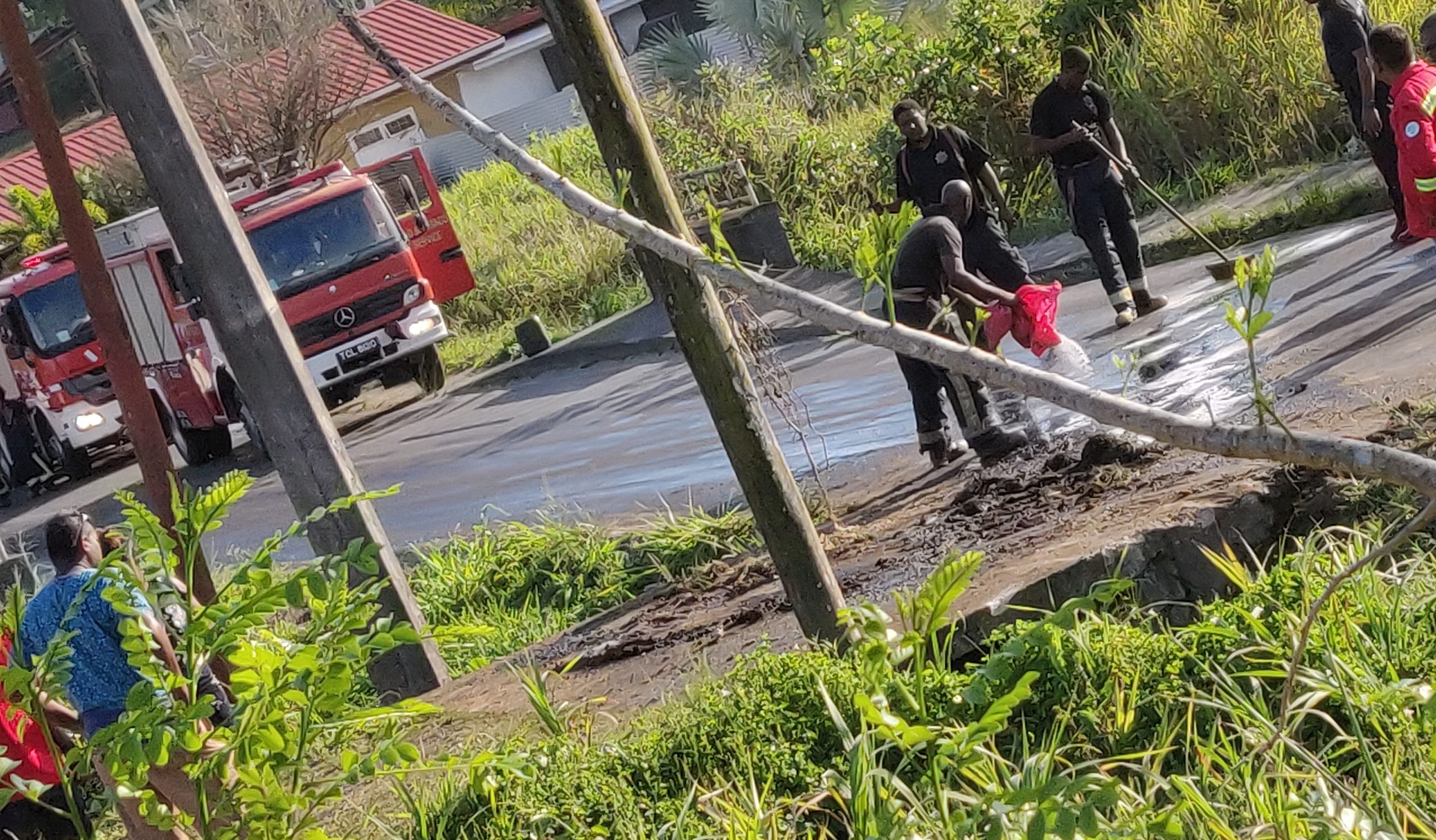 April 2023. Fire Officers cleaning up leaked diesel at the sitre of a crash on Madras Road. Photograph taken by Neela Ramsundar