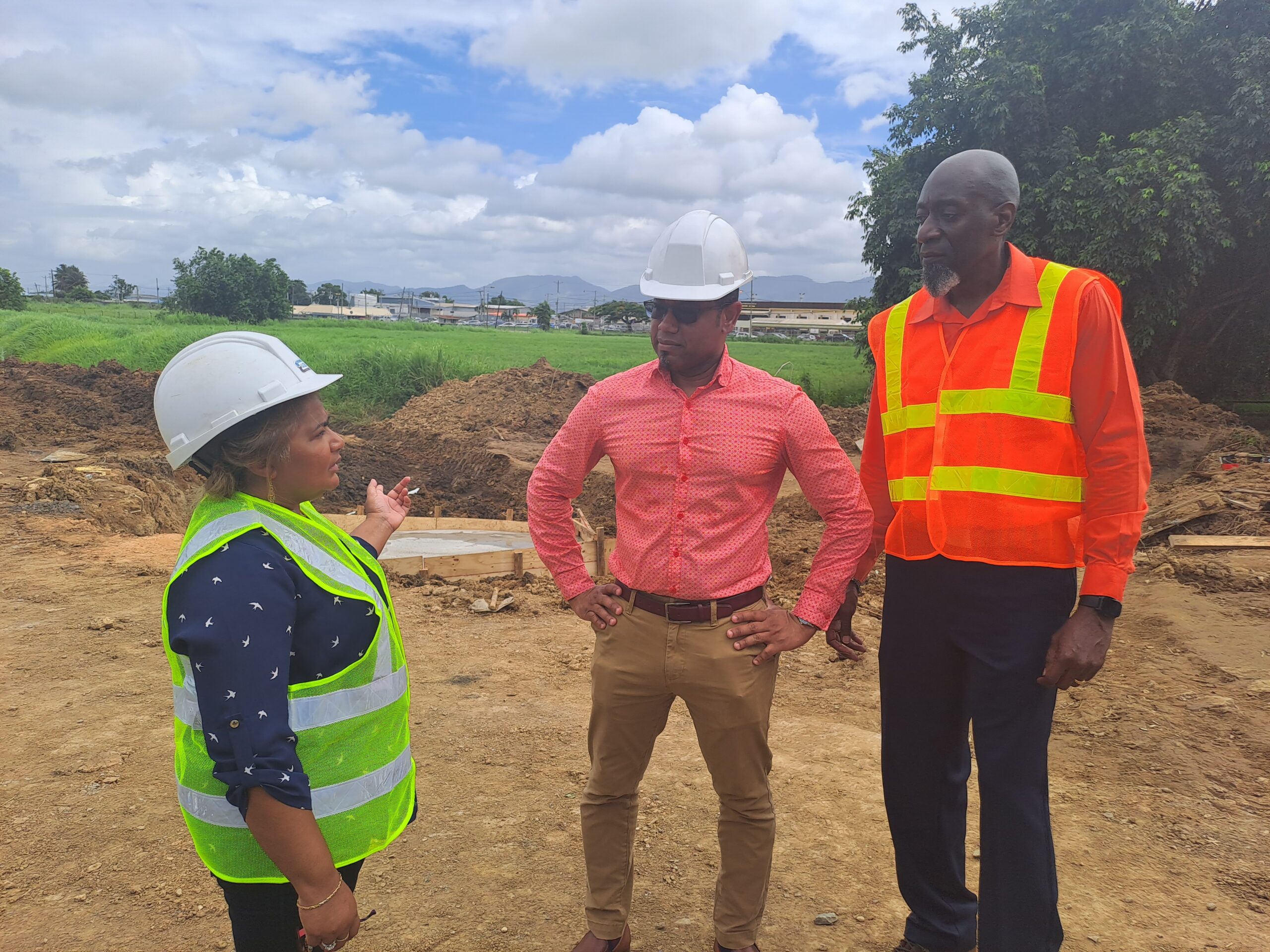 WASA’s acting CEO Kelvin Romain, centre, Head of Operations Shaira Ali, left, and Manager of Corporate Communications Daniel Plenty near the site of repairs to the 48-inch transmission line. AZP News/Prior Beharry