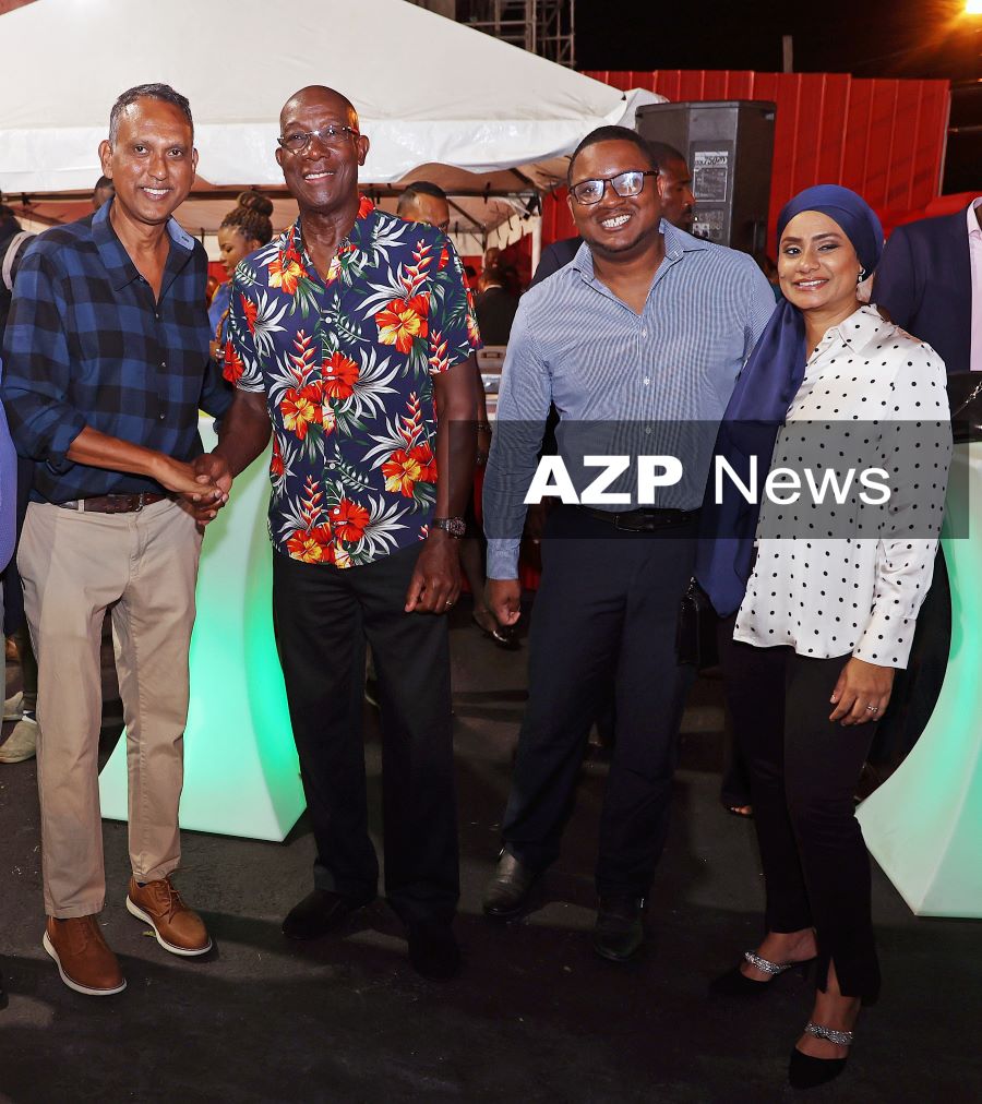 Prime Minister Dr Keith Rowley, second left, with AZP News Chief Photographer Azlan Mohammed, left, and CNC3's Kejan Haynes and Kristy Ramnarine, right