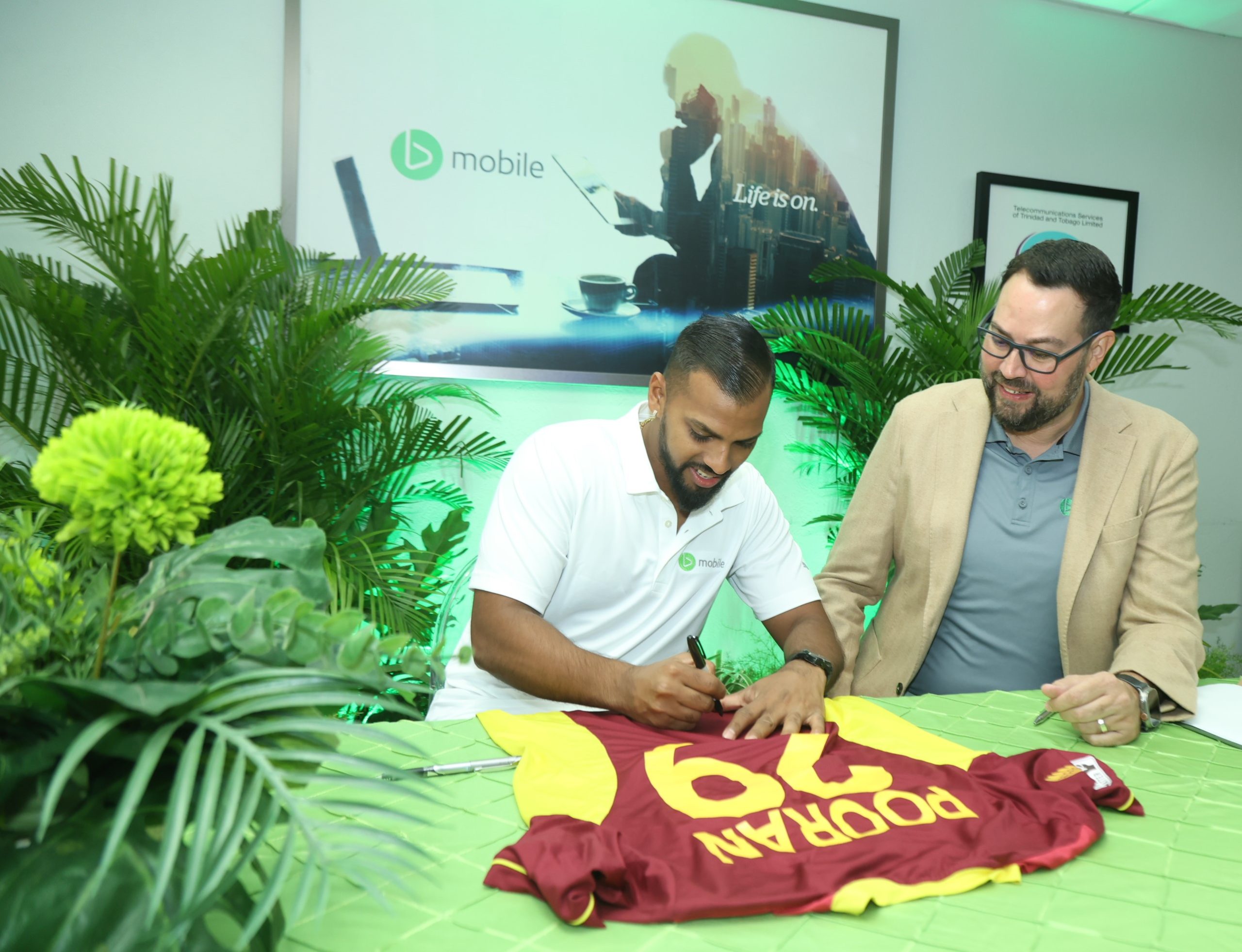 's newest brand ambassador autographs a T-shirt to mark the occasion