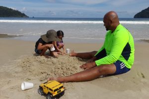 Caption: Having fun in the sun. Simeon Seepersad from Penal plays in the sand at Maracas Bay with his four-year-old daughter Sapphire and her cousin Ailon Bailey also four-years-old from Gasparillo. AZP News/Sue-Ann Wayow