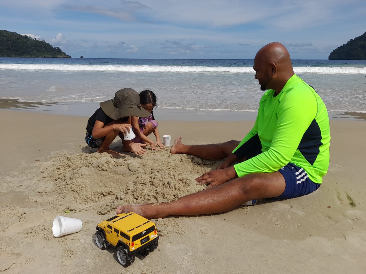 Caption: Having fun in the sun. Simeon Seepersad from Penal plays in the sand at Maracas Bay with his four-year-old daughter Sapphire and her cousin Ailon Bailey also four-years-old from Gasparillo. AZP News/Sue-Ann Wayow