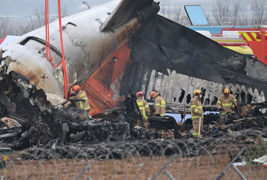 Firefighters and recovery teams work at the scene where a Jeju Air Boeing 737-800 series aircraft crashed and burst into flames at Muan International Airport in Muan, some 288 kilometres southwest of Seoul on December 30, 2024. AFP/Jung Yeon-Je