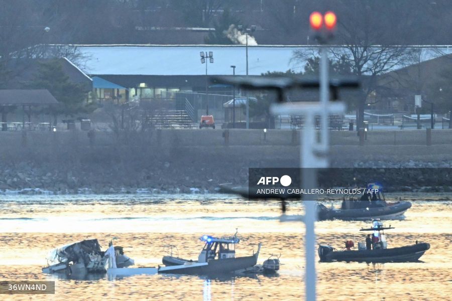 Caption: Part of the wreckage is seen as rescue boats search the waters of the Potomac River after a plane on approach to Reagan National Airport crashed into the river outside on Thursday. AFP/Andrew Caballero-Reynolds  Jan 30, 2025