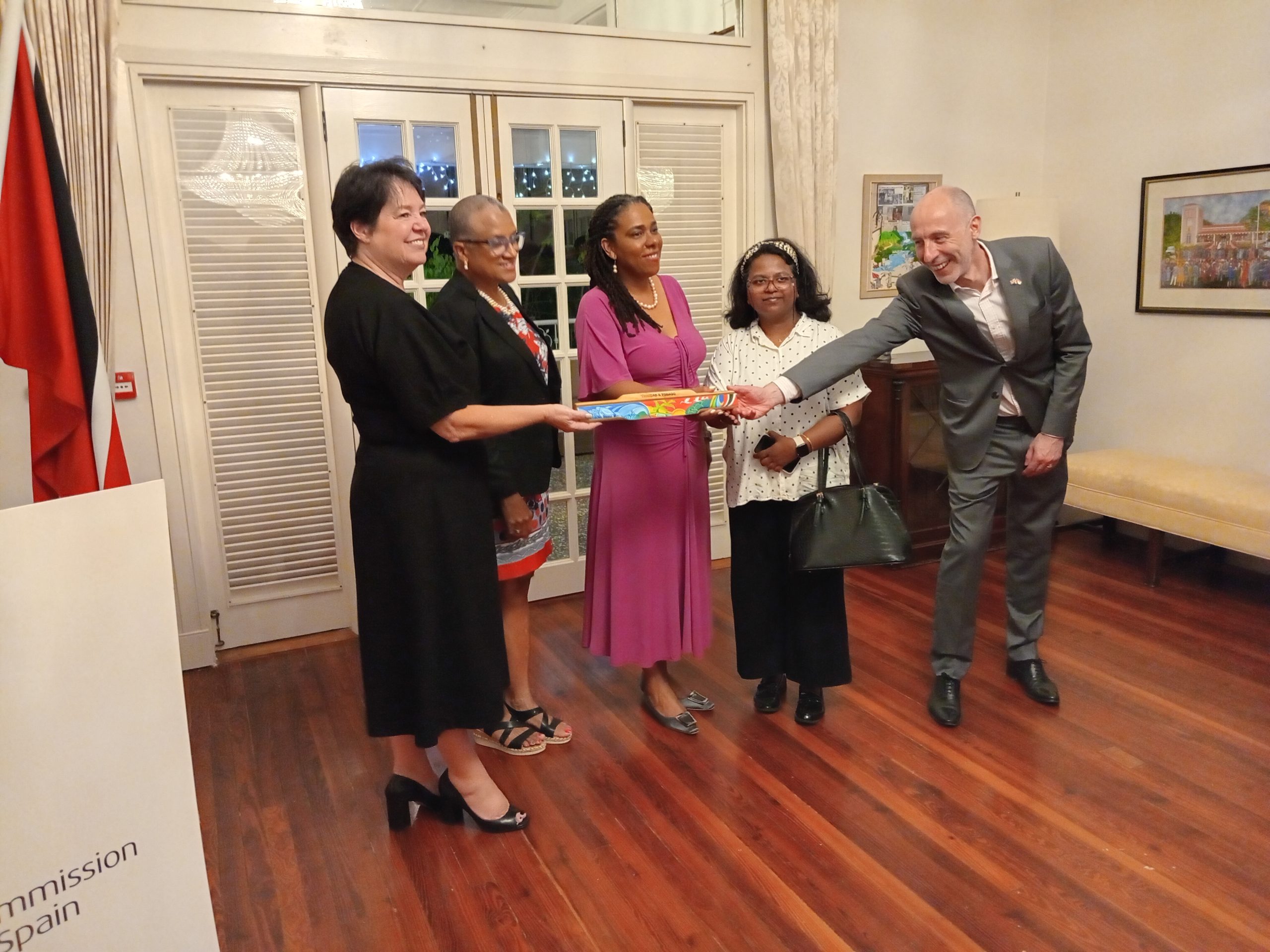 Caption UK High Commissioner Jon Dean touches the baton