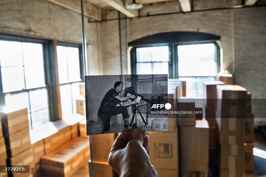 Caption: A 1964 historic federal law enforcement photo of the post John F Kennedy assassination investigation shows FBI agent Robert Frazier reenacting the JFK assassination near its original location at the Texas School Book Depository building in Dallas, Texas October 8, 2013