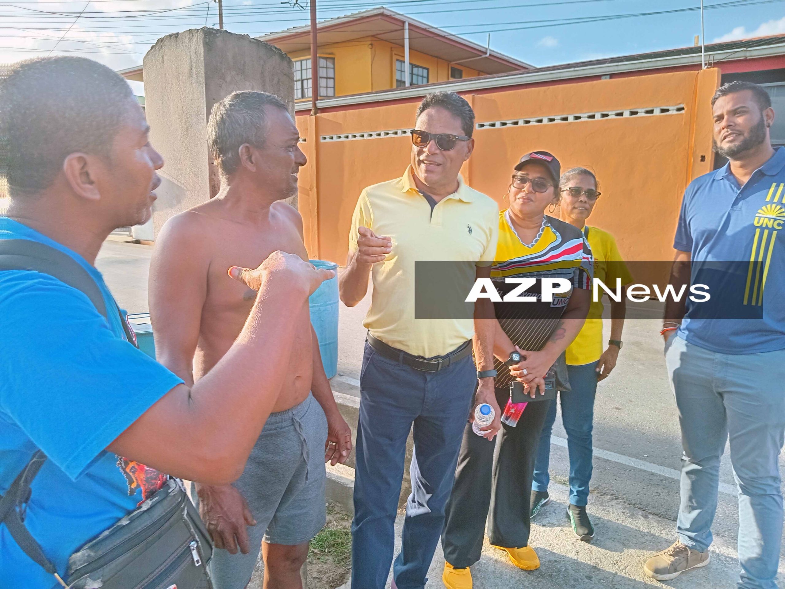 Caption: UNC candidate for Aranguez/ St Joseph Devesh Maharaj speaks with residents of Sooknanan Street in Aranguez. AZP News/Prior Beharry