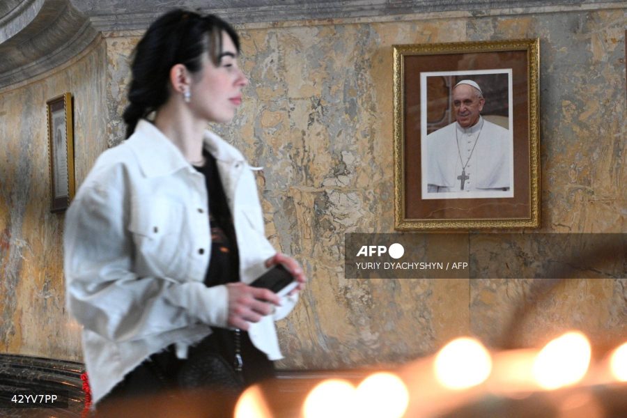 Caption: A woman walks by a portrait of Pope Francis in the Church of the Blessed Eucharist in the city of Lviv, on April 21, 2025, amid the Russian invasion of Ukraine. Pope Francis died on April 21, 2025 aged 88, a day after making a much hoped-for appearance at Saint Peter's Square on Easter Sunday, the Vatican said in a statement. AFP/Yuriy Dyachyshyn