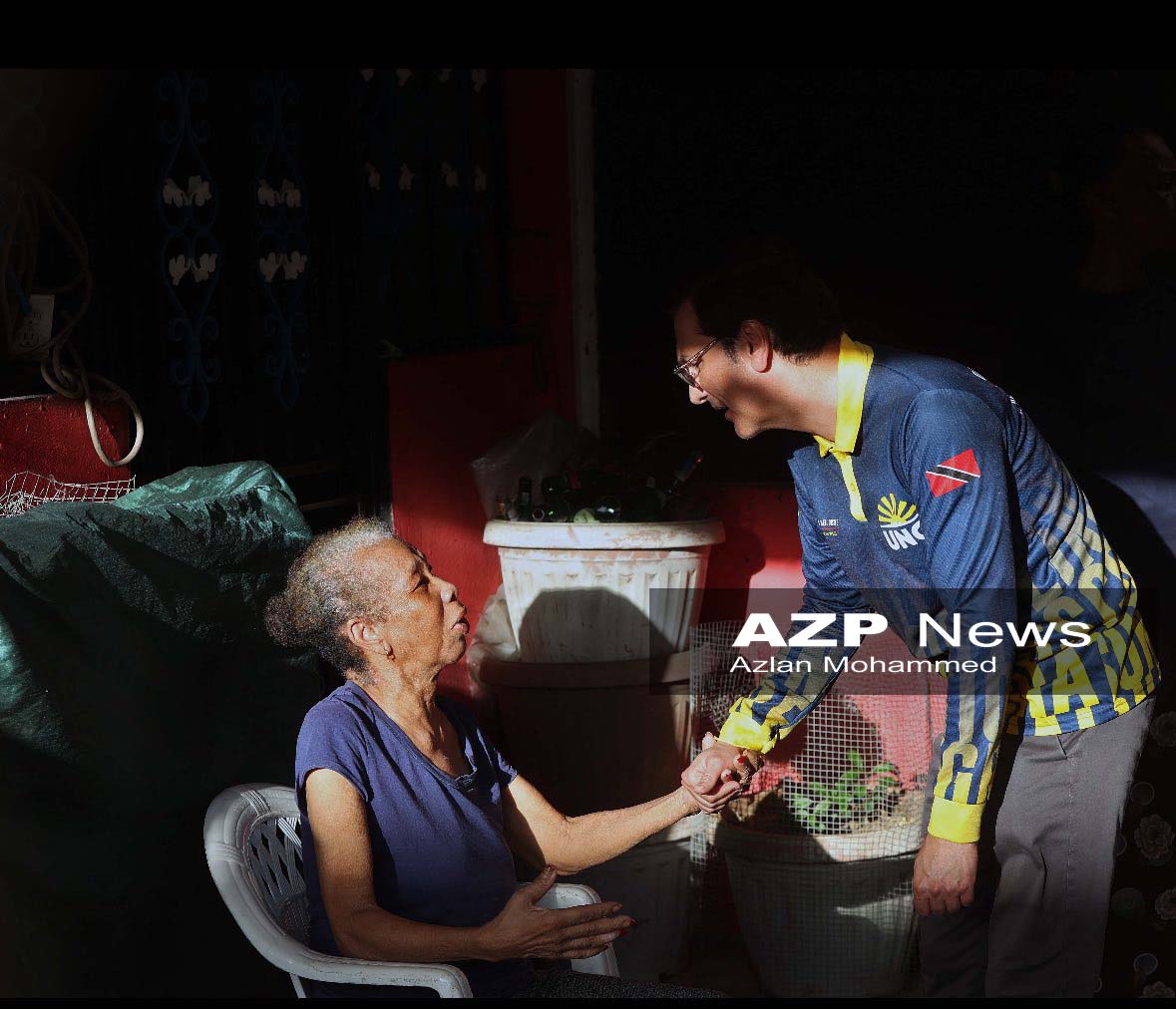 Caption: UNC's Chaguanas West candidate, Dr Neil Gosine listens attentively to the concerns of the elderly at Frederick Settlement, Caroni