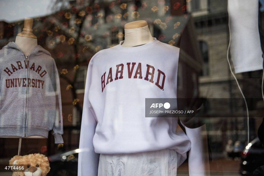 (FILES) Harvard sweatshirts are displayed for sale in a school store window on the Harvard University campus in Cambridge, Massachusetts, on April 15, 2025. US President Donald Trump's administration on Thursday revoked Harvard's right to enroll foreign students -- more than a quarter of its annual enrollment -- in a major escalation of the president's fight with one of the world's most storied universities. Trump is furious at Harvard -- which has produced 162 Nobel prize winners -- for rejecting his demand that it submit to oversight on admissions and hiring over his claims that it is a hotbed of anti-Semitism and "woke" liberal ideology. (Photo by Joseph Prezioso / AFP)
