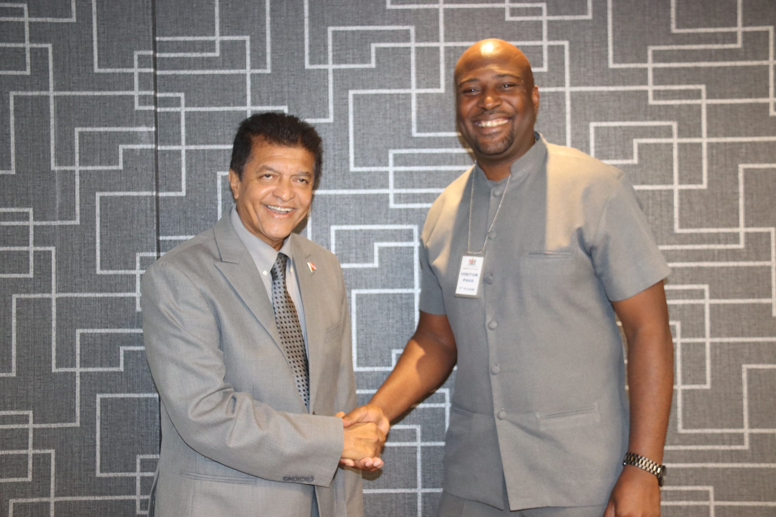 Caption: Health Minister Dr Lackram Bodoe, left, shakes hands with President of the Trinidad and Tobago National Nurses Association Idi Stuart