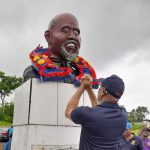 President General of the OWTU Ancel Roget lays a wreath at the grave of Tubal Uriah 'Buzz' Butler. AZP News/Sue-Ann Wayow
