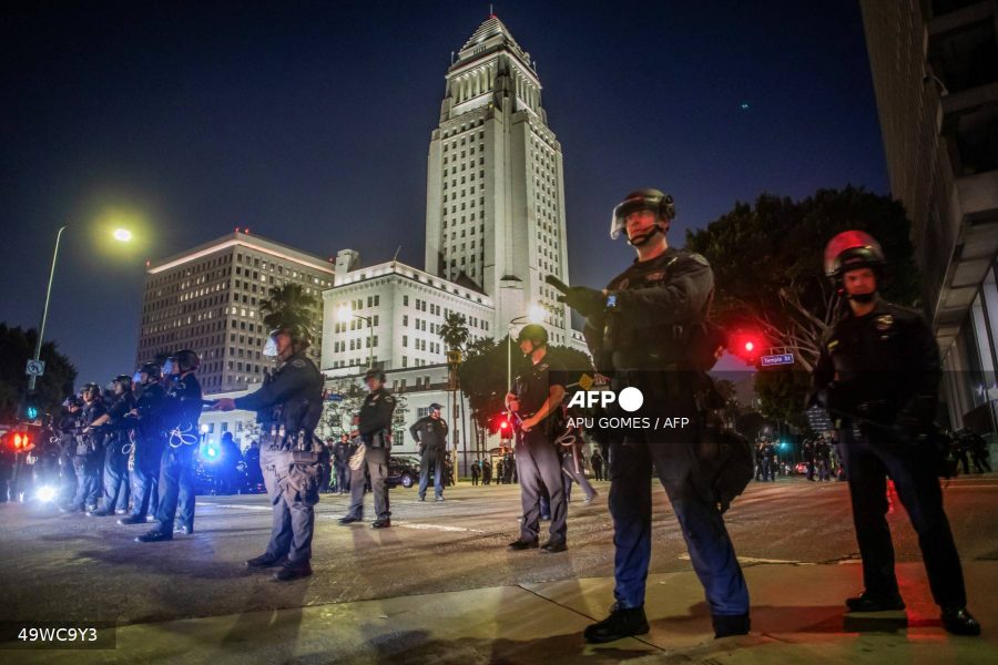 Los Angeles Metro Police officers stand on the road in front of the City Hall after a curfew was put into effect following days of protests in response to federal immigration operations in Los Angeles on June 10, 2025