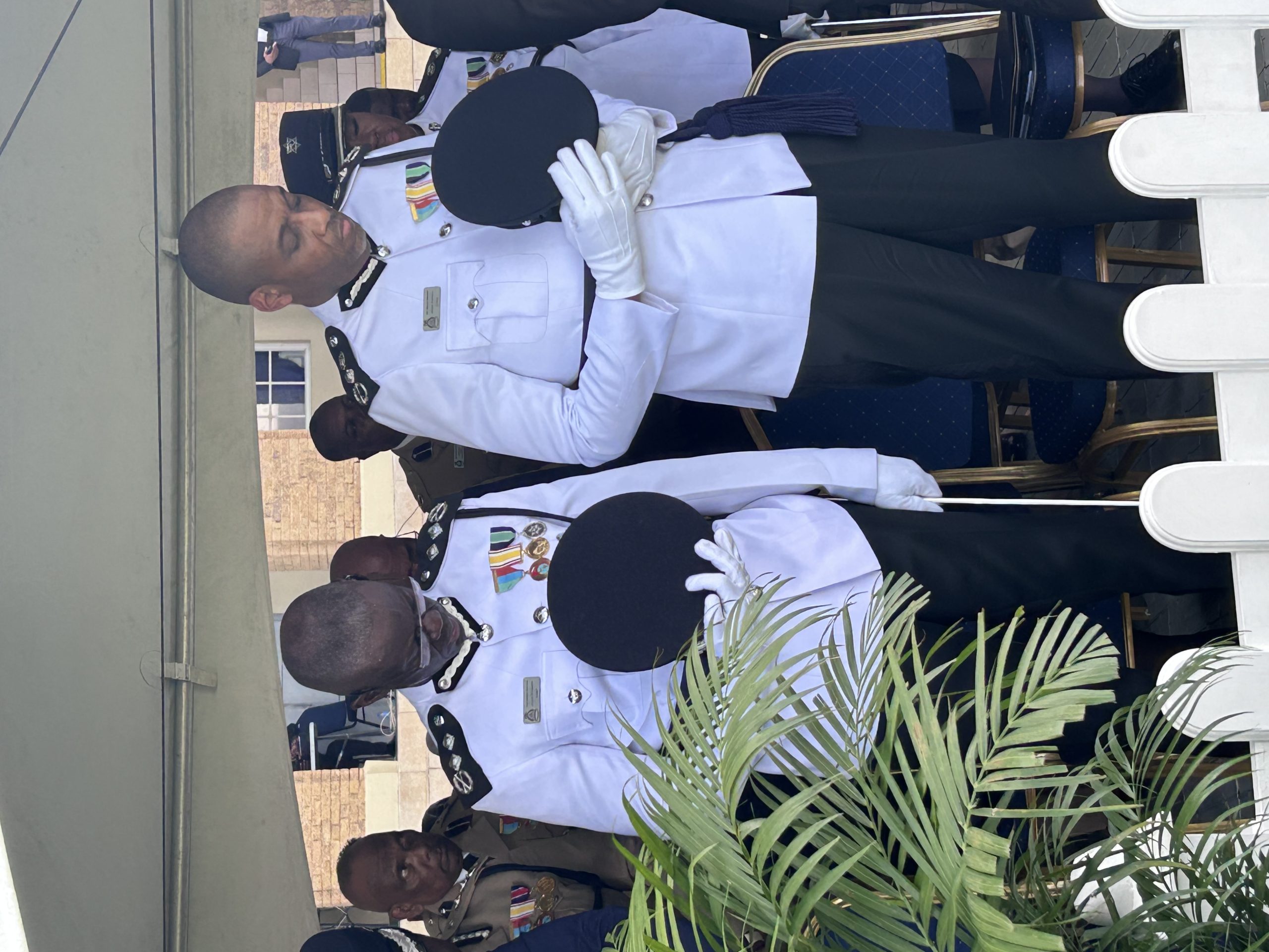 Former acting Commissioner of Police Junior Benjamin, left and newly appointed Commissioner of Police Allister Guevarro bow their heads in silence during the opening prayer of Guevarro's appointment ceremony on Tuesday at the Police Barracks, St James. AZP News/Alicia Chamely