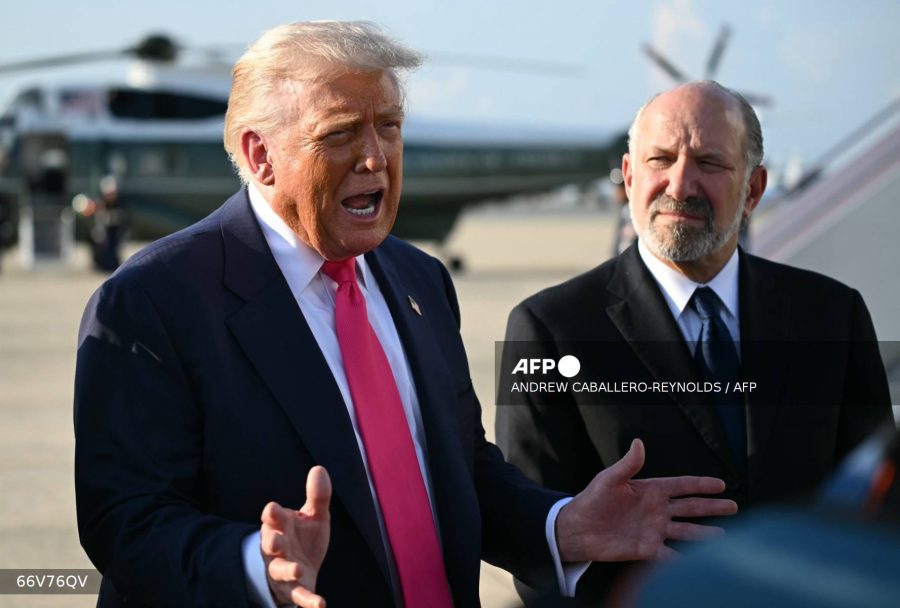 Caption: US President Donald Trump, left, flanked by US Secretary of Commerce Howard Lutnick, speaks to reporters after stepping off Air Force One upon arrival at Joint Base Andrews, Maryland on July 15, 2025