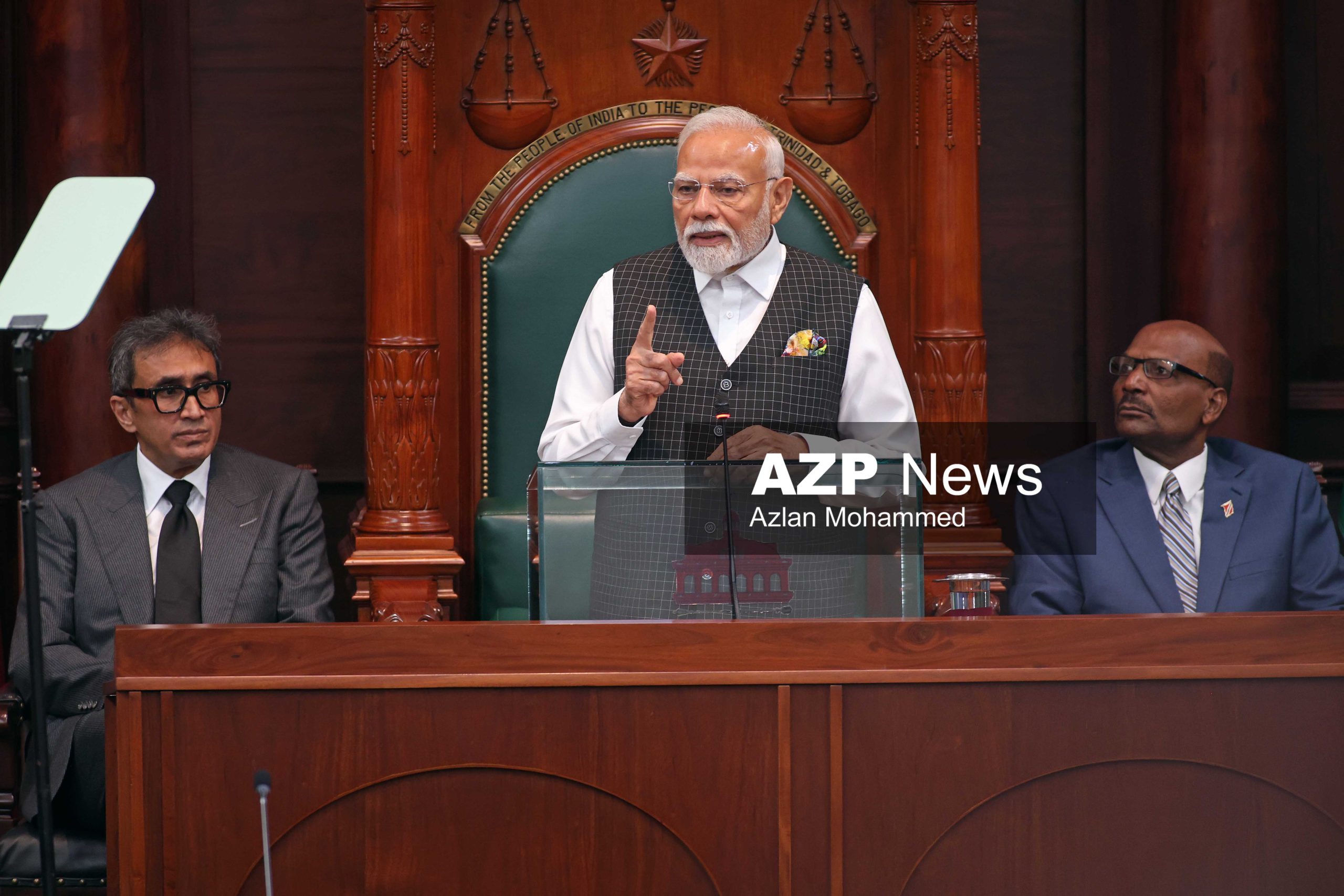 Prime Minister Narendra Modi addresses a Joint Sitting of Parliament on Friday with House Speaker Jagdeo Singh, left, and Senate President Wade Mark on Friday