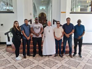 Rt Rev John Pereira, Abbot of Mount St Benedict, with ministers and officials of T&TEC