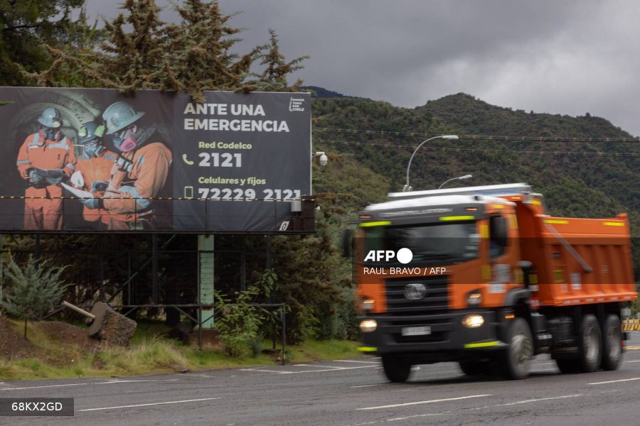 A truck drives past an emergency sign at the entrance to the El Teniente mine, a Codelco copper mine in the commune of Machali, near Rancagua, O'Higgins Region