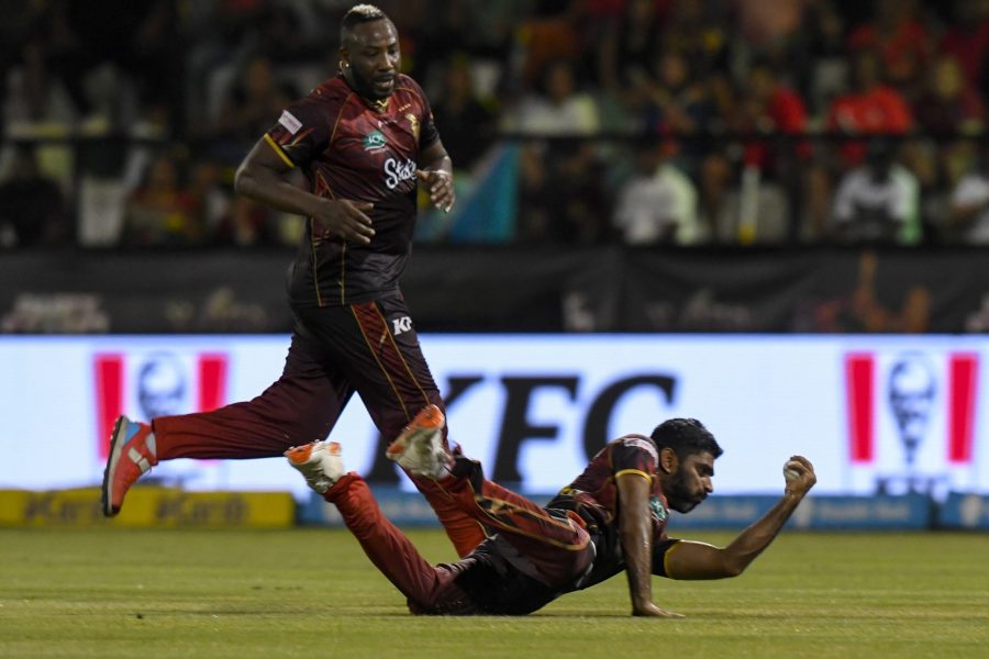 Andre Russell, left, watches as Saurabh Netravalkar of TKR, takes the catch to dismiss Johnson Charles of Saint Lucia Kings. Photo: CPL T20 via Getty Images