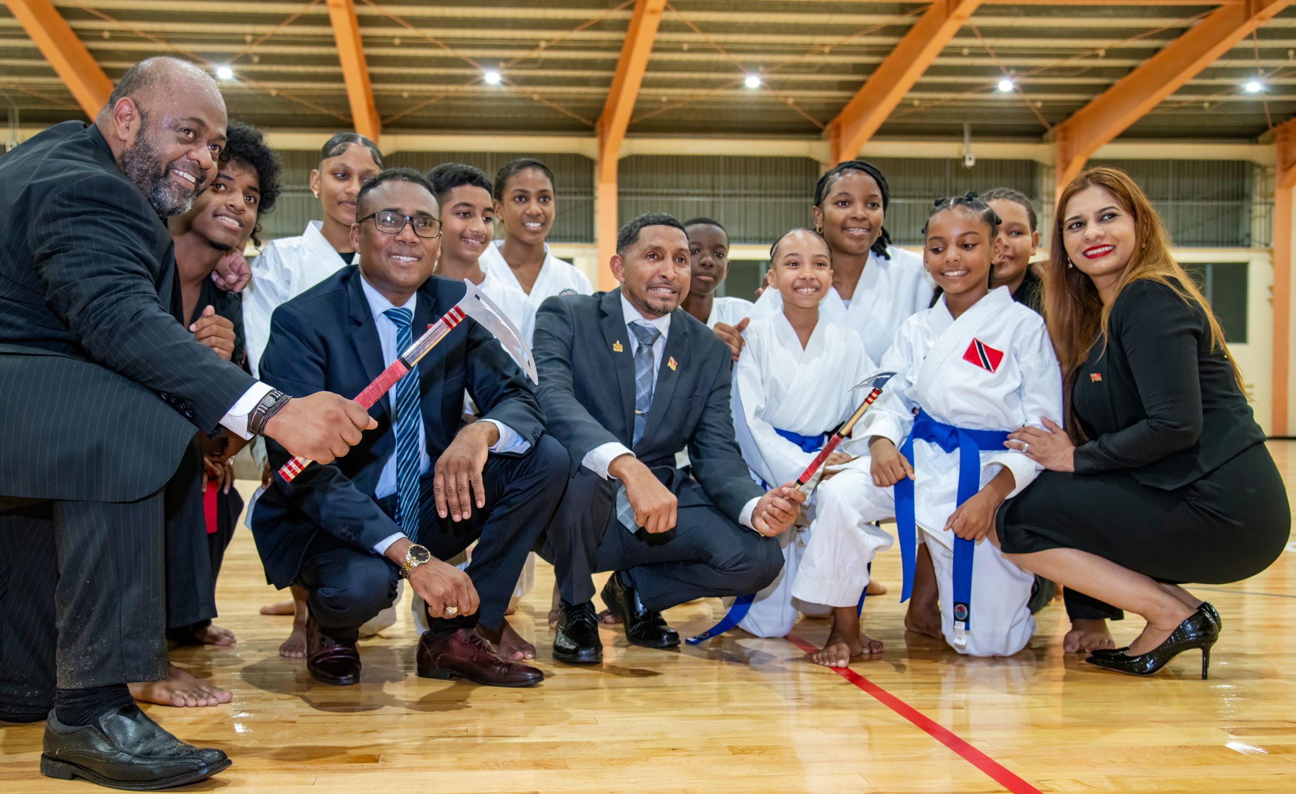 From left  MP for Toco/ Sangre Grande Wayne Sturge, Minister of Sports Phillip Watts, Minister in the Ministry of Public Utilities Clyde Elder and Ministry of Public Utilities Parliamentary Secretary Shivanna Sam pose with Team Elite Karate on Monday at the reopening of the North EasternRegional Multipurpose Sport Faciltiy in Sangre Grande. Photo: MSYA