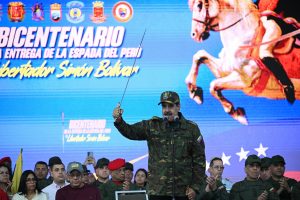 Venezuela’s President Nicolás Maduro delivers a speech while holding Venezuelan independence hero Simón Bolívar’s “Sword of Peru” during a military ceremony at Fuerte Tiuna in Caracas, on November 25, 2025. AFP/ Federico Parra