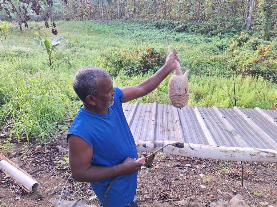 Caption: Holding a tattoo/armadillo at a camp in Navet on the last hunting day on Saturday