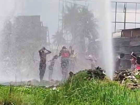 Caption: In this screen grab from TV6 Facebook page, residents of the Beetham turn this leak into an impromptu water park