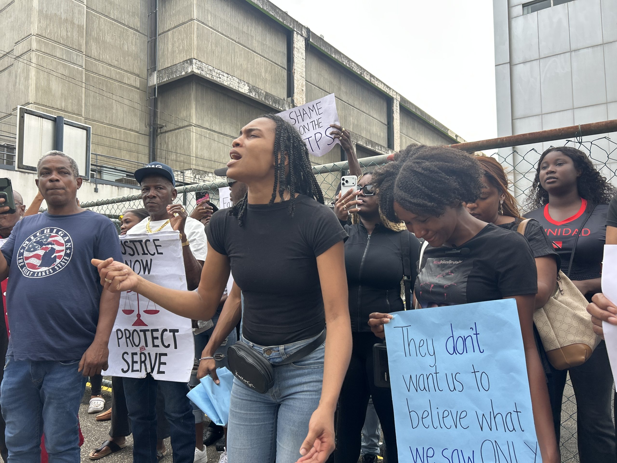 Caption: Mariah Walcott chants 'Shame on the TTPS,' demanding the removal of CoP Allister Guevarro. AZP News/Alicia Chamely