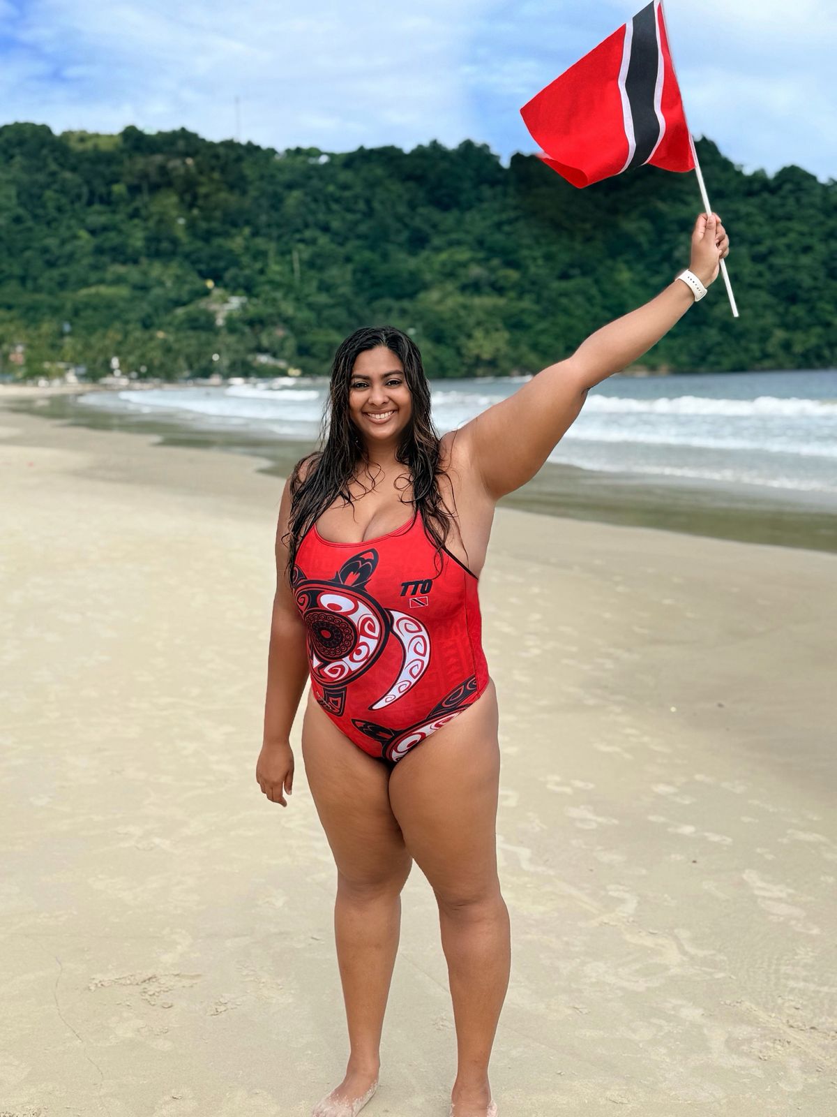 Caption: Dr Chelseaia Charran flying the T&T flag