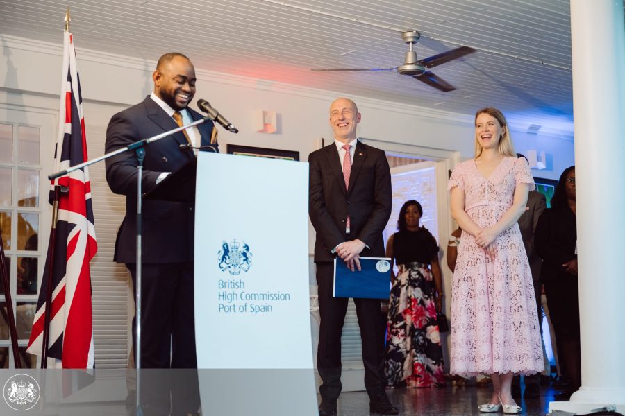 Minister of Foreign and CARICOM Affairs at the podium as British High Commissioner Jon Dean and his wife Olga look on. Photo: British High Commission