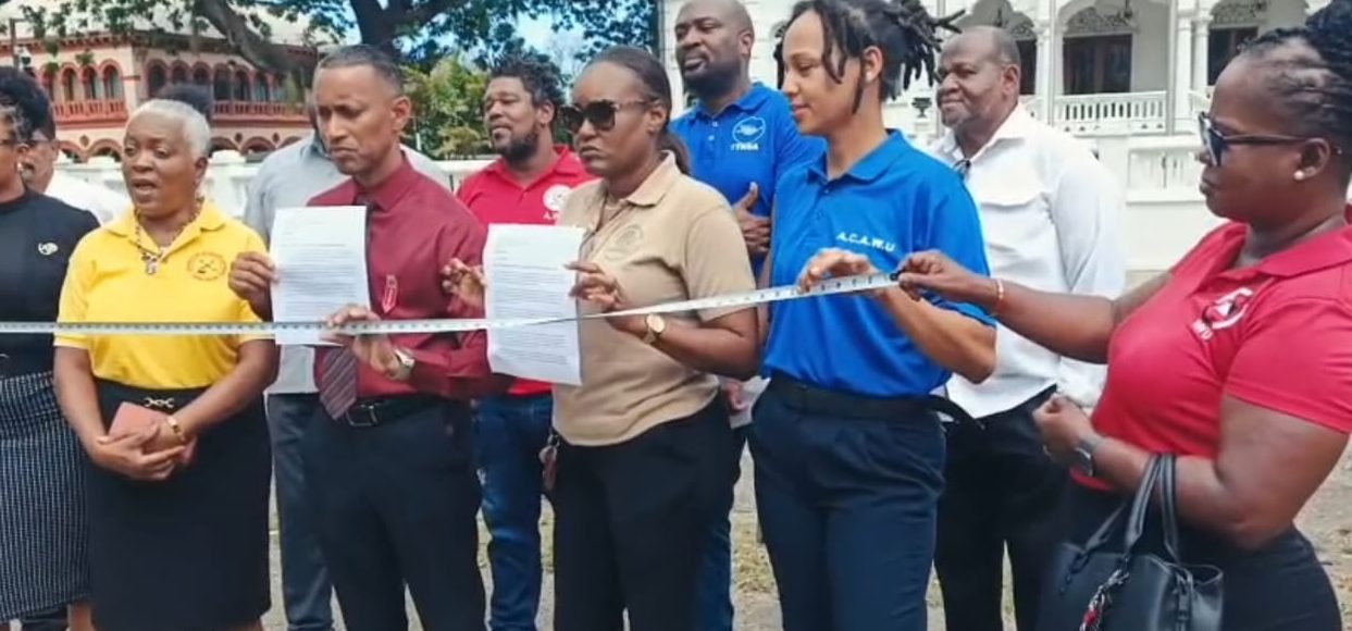 Caption: Representatives of various trade unions hand deliver a letter requesting a meeting with Prime Minister Kamla Persad-Bissessar at her office at White Hall, Queens Park Savannah West, Port of Spain. Photo: TTUTA