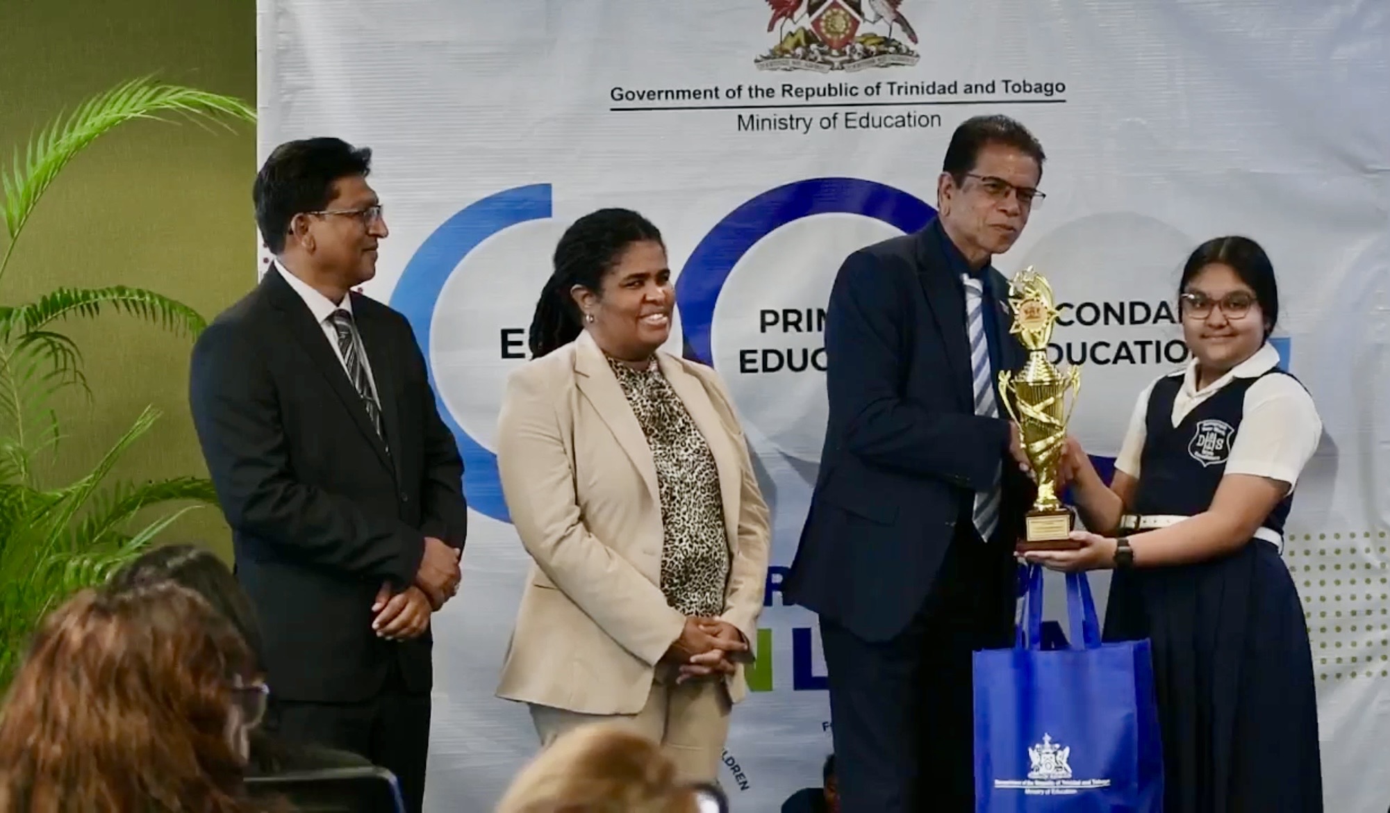 Caption: Education Minister Dr Micheal Dowlath presents one of the nine top SEA achiever awards to Shazana Mohammed of Debe Hindu School